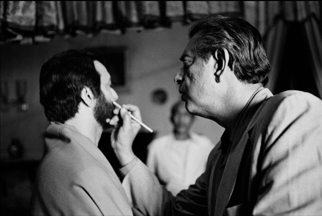 Fixing Soumitra Chatterjee’s makeup on the set of Ghare Baire (aka The Home and the World, 1984). Photo credit: Nemai Ghosh.